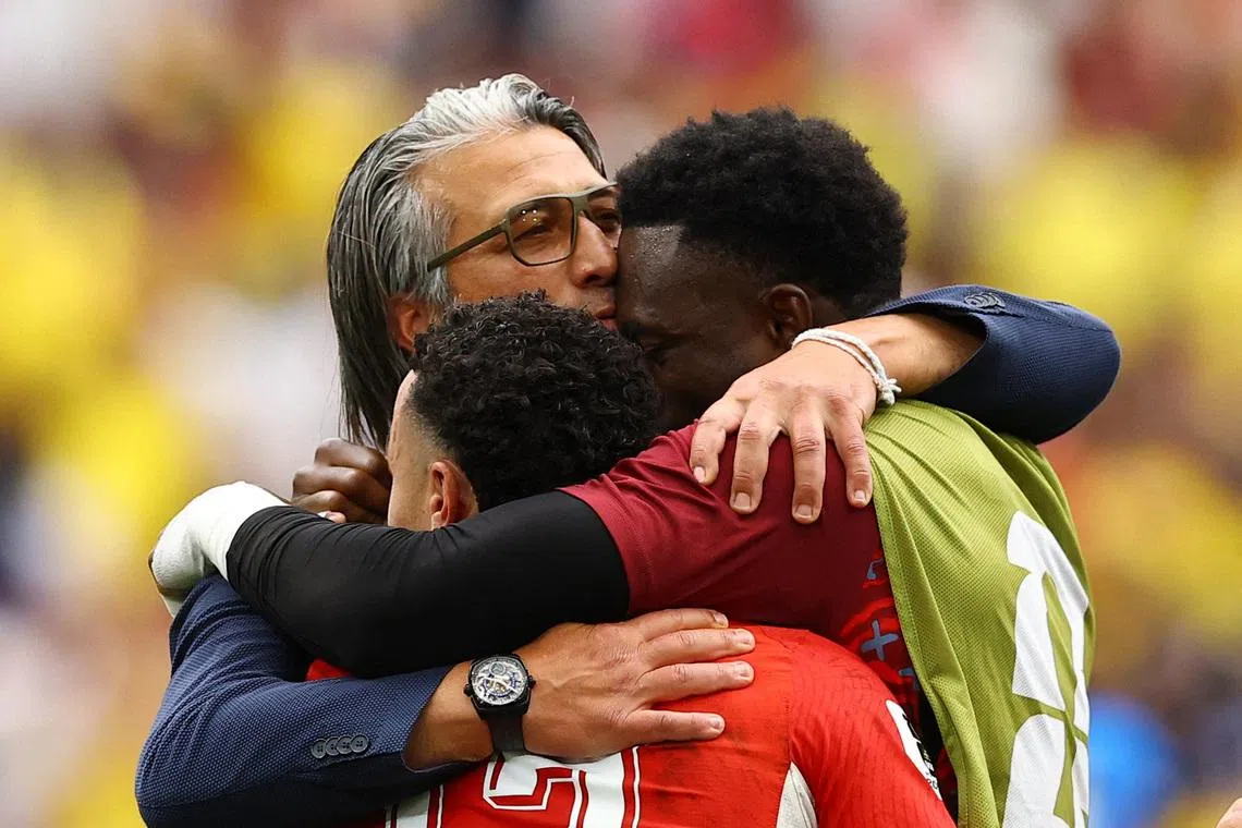 Switzerland coach Murat Yakin celebrates with his players.