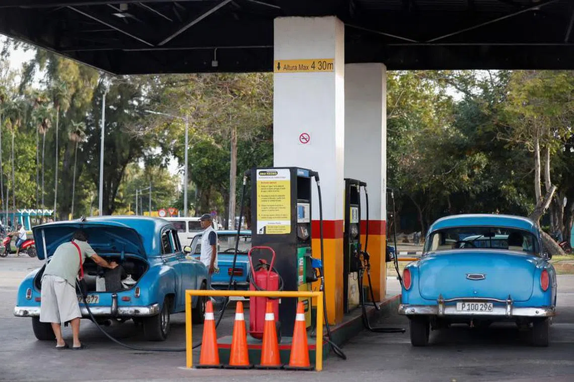 FILE PHOTO: A man fills up a jerry can at a gas station, as the government announced it will hike the retail price of its 94 octane gasoline from 30 to 156 pesos per litre beginning February 1, in Havana, Cuba January 9, 2024. REUTERS/Yander Zamora