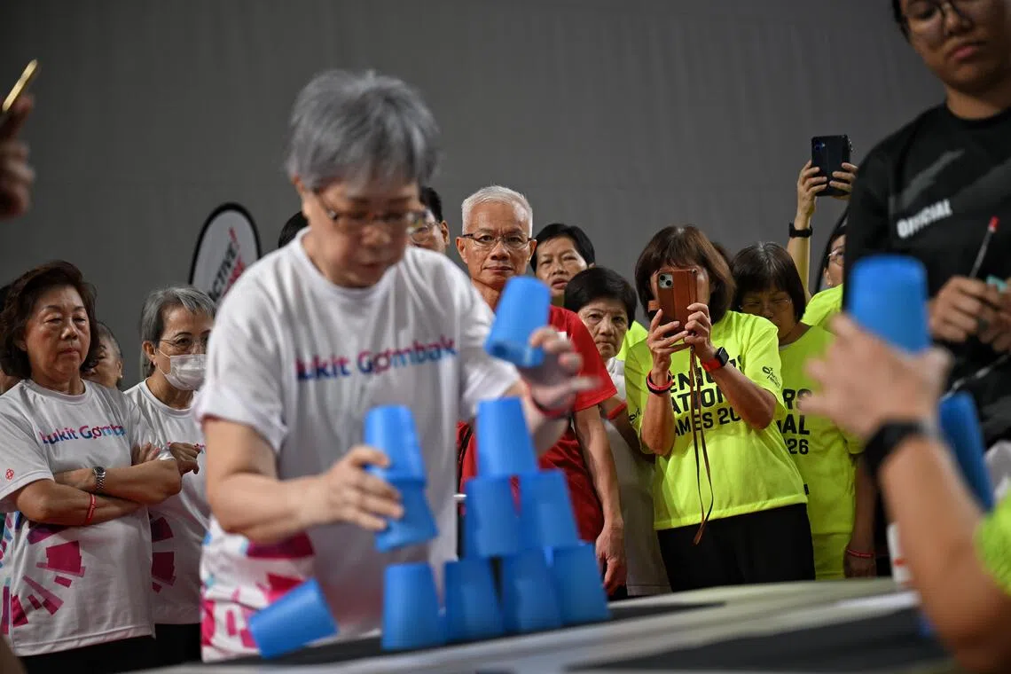 Participants take videos as seniors take part in the Sport stacking segment during the Seniors National Games Finals held at the OCBC Arena on August 4, 2026.