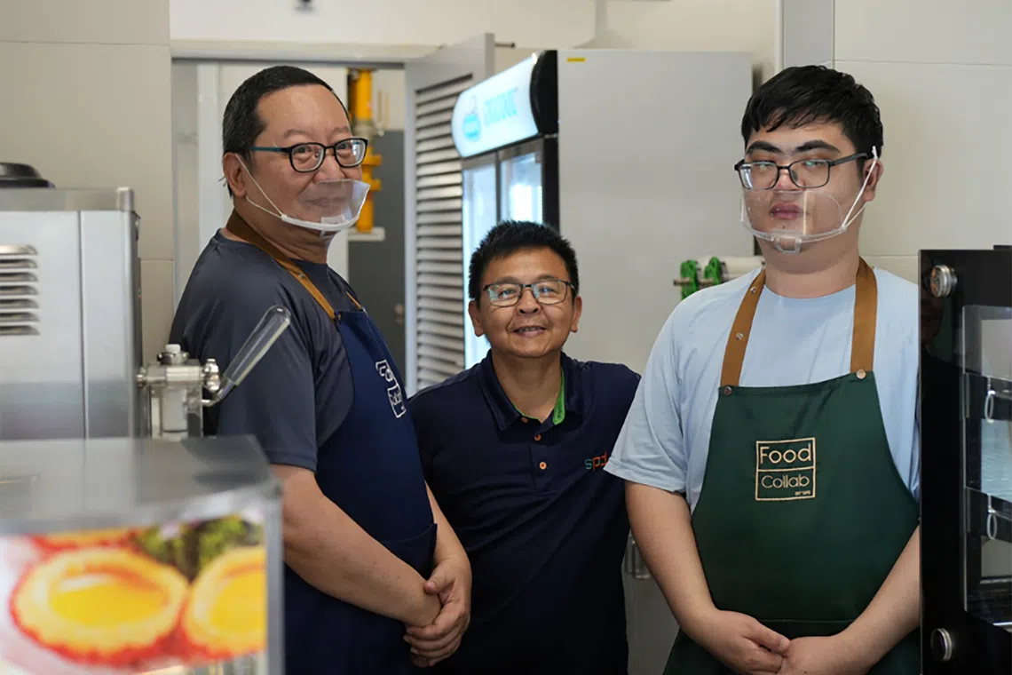 Edmund Ho (left), who has a cognitive and speech impairment and Low Kah Gin (right), who has autism spectrum disorder, work at Yusof Ishak Secondary School’s canteen under SPD’s employment program. With them is SPD staff and operations supervisor Foo Boon How.
