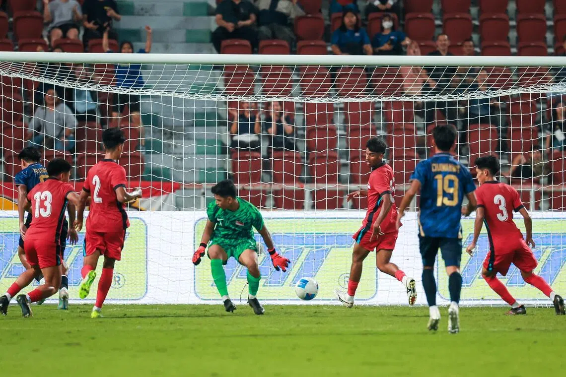 Singapore U-22s goalkeeper Aizil Yazid is unable to keep out a Thai strike during their 3-0 loss at the Rajamangala National Stadium in Bangkok on Dec 11.