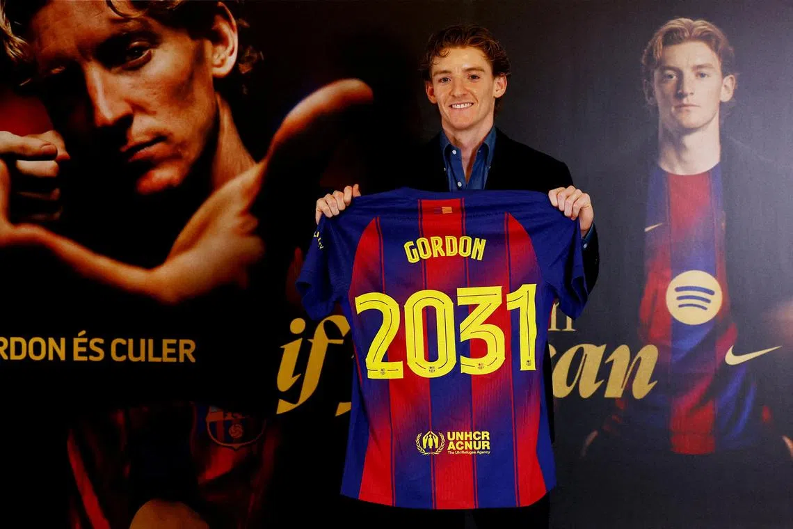 Soccer Football - Anthony Gordon signs for FC Barcelona - Spotify Camp Nou, Barcelona, Spain - May 29, 2026 Anthony Gordon poses as he holds a shirt after signing for FC Barcelona REUTERS/Albert Gea