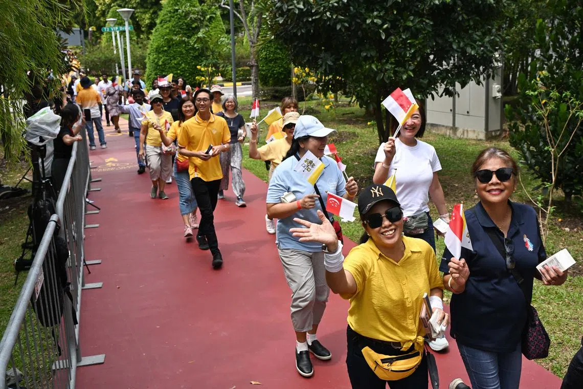 Members of the Catholic community walking along Changi Airport Connector leading to Jurassic Mile where they will welcome the Pope when he reaches Singapore on Sept 11, 2024. 