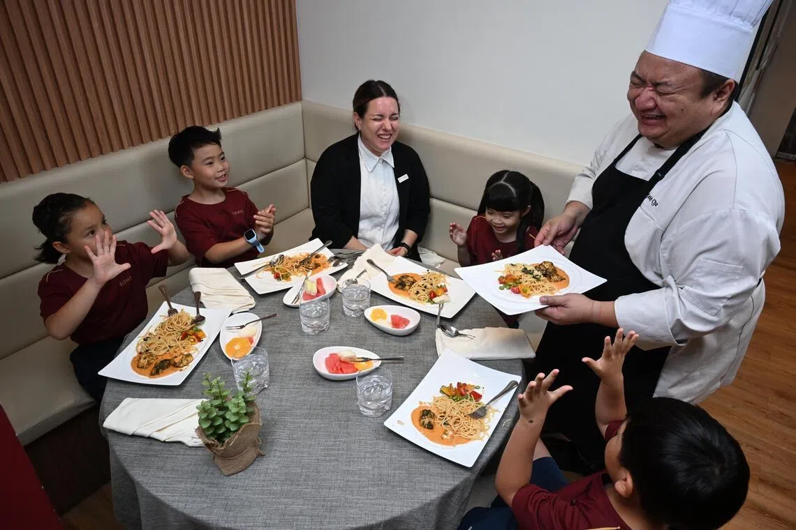 Pupils enjoying a fine-dining style set-up designed to teach table manners at Elevate After School Care by EtonHouse.