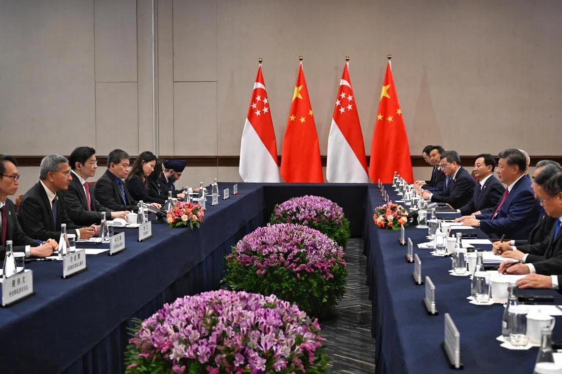 PM Lawrence Wong (left) meets Chinese President Xi Jinping with their respective delegations at a bilateral meeting during the Apec summit in Lima, Peru on Nov 15.