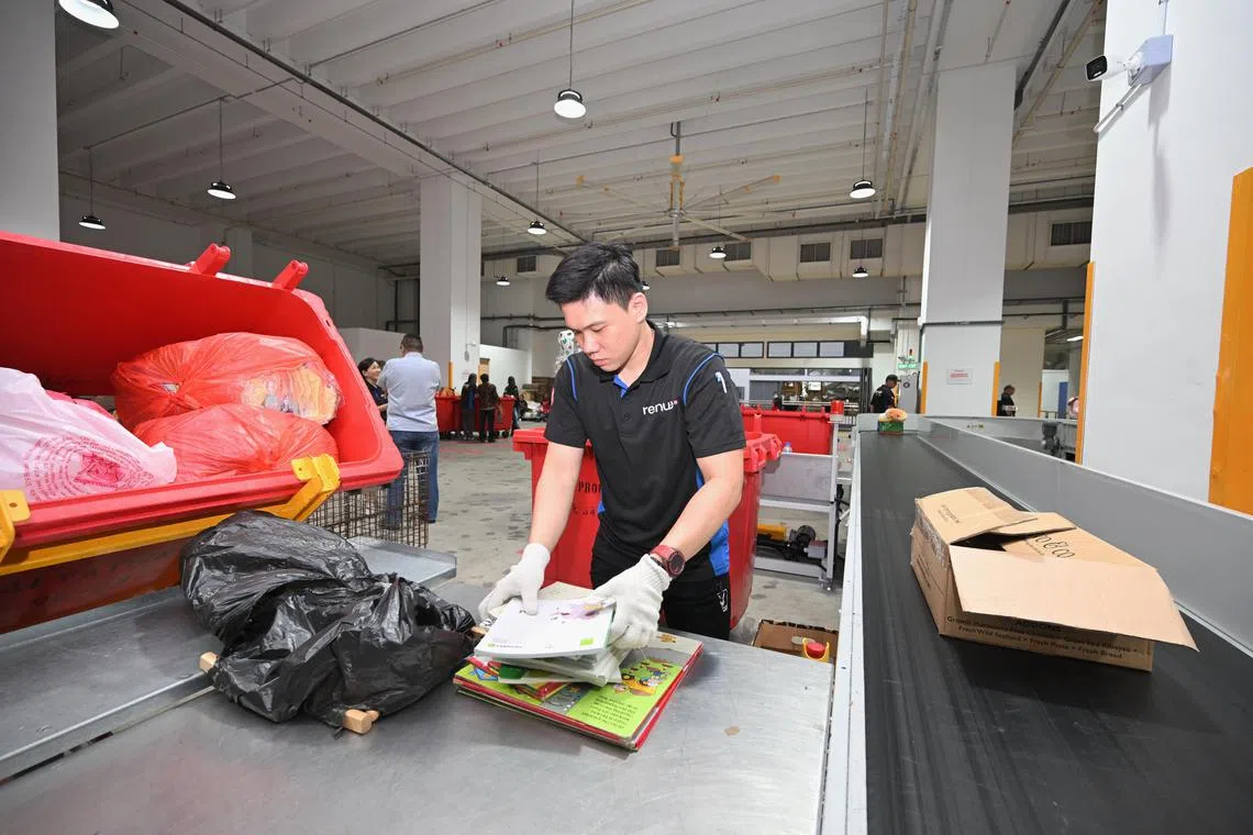 The donated items are sorted into boxes and placed on a conveyor belt, as seen at Re:Nue new facility at JTC Defu Industrial City, as seen on May 15, 2025.