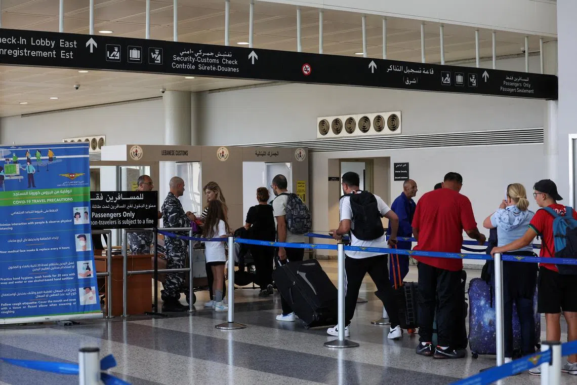 People wait in line at Lebanese customs at the Beirut–Rafic Hariri International Airport, in Beirut, Lebanon July 30, 2024. REUTERS/Mohamed Azakir