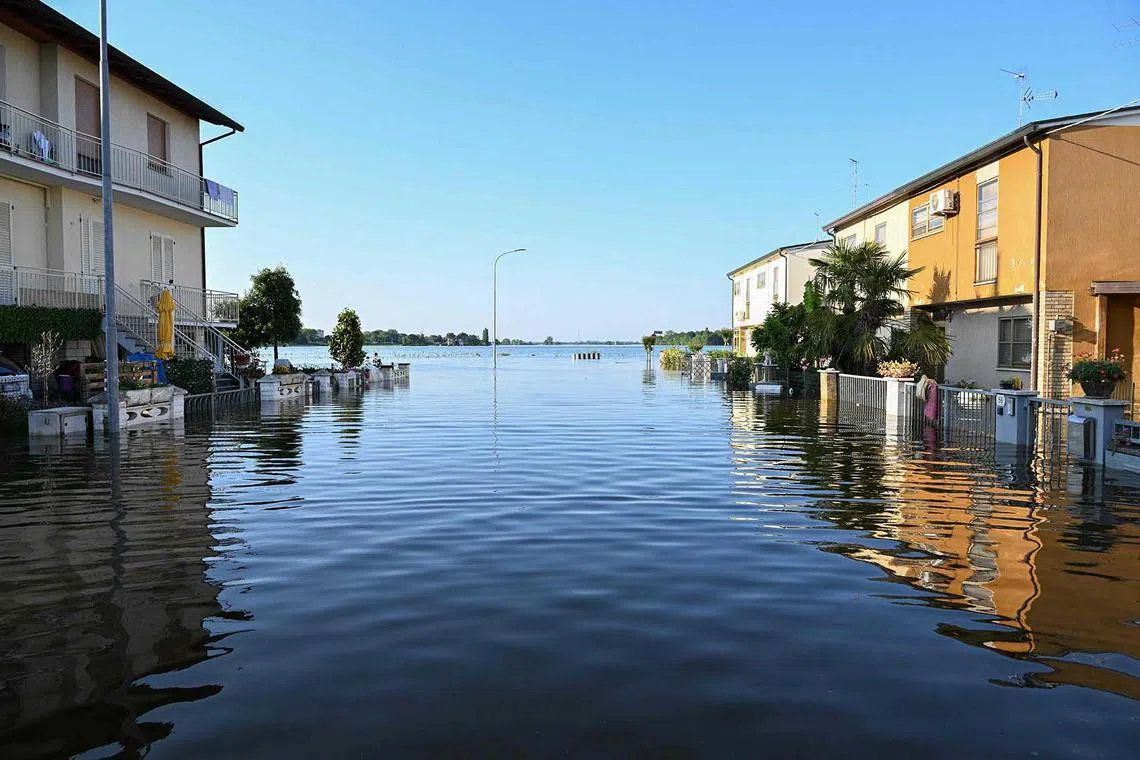 A general view shows a flooded street on May 21, 2023 in Conselice, near Ravenna, after deadly floodwaters hit the Emilia-Romagna region. More than 36,000 people have now been forced from their homes by deadly floods in northeast Italy, regional officials said, as rising waters swallowed more houses and fresh landslides isolated hamlets. Violent downpours earlier this week killed 14 people, transforming streets in the cities and towns of the Emilia Romagna region into rivers. (Photo by Andreas SOLARO / AFP)