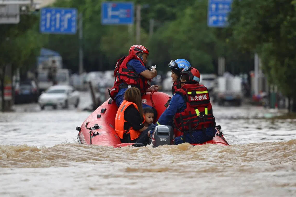 Rescue workers evacuating residents stranded by floodwaters in Huaiji, China, on June 18.