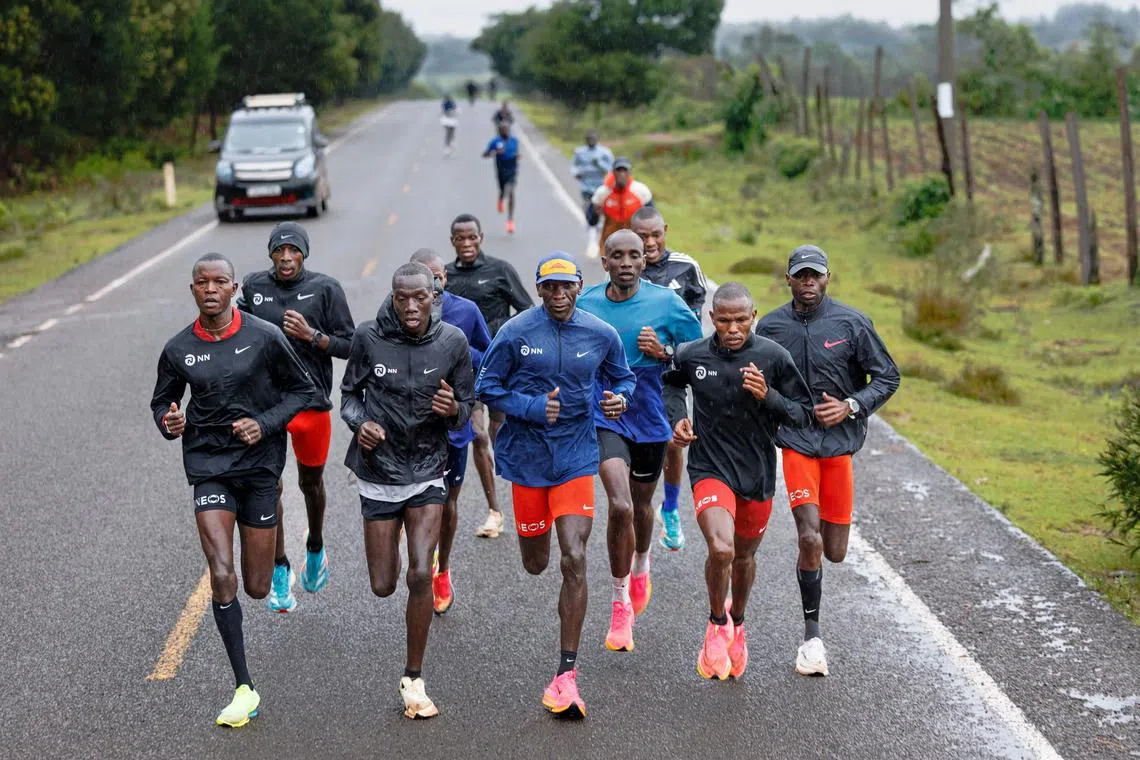 Olympic marathon champion Eliud Kipchoge (centre) runs among his pacers during a training session in Kaptagat on May 4, 2024.