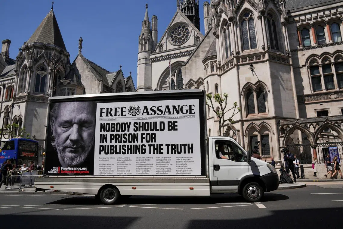 FILE PHOTO: A car with a message in support of WikiLeaks founder Julian Assange drives in front of the High Court, on the day of an extradition hearing of Julian Assange, in London, Britain, May 20, 2024. REUTERS/Maja Smiejkowska/File Photo