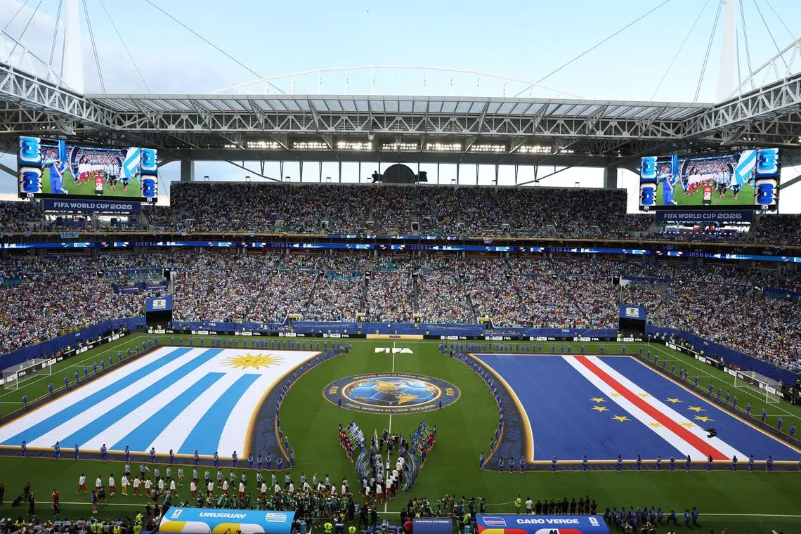 Soccer Football - FIFA World Cup 2026 - Group H -  Uruguay v Cape Verde - Miami Stadium, Miami Gardens, Florida, U.S. - June 21, 2026 General view inside the stadium of giant Uruguay and Cape Verde flags as the teams walk out onto the pitch before the match REUTERS/Paul Childs