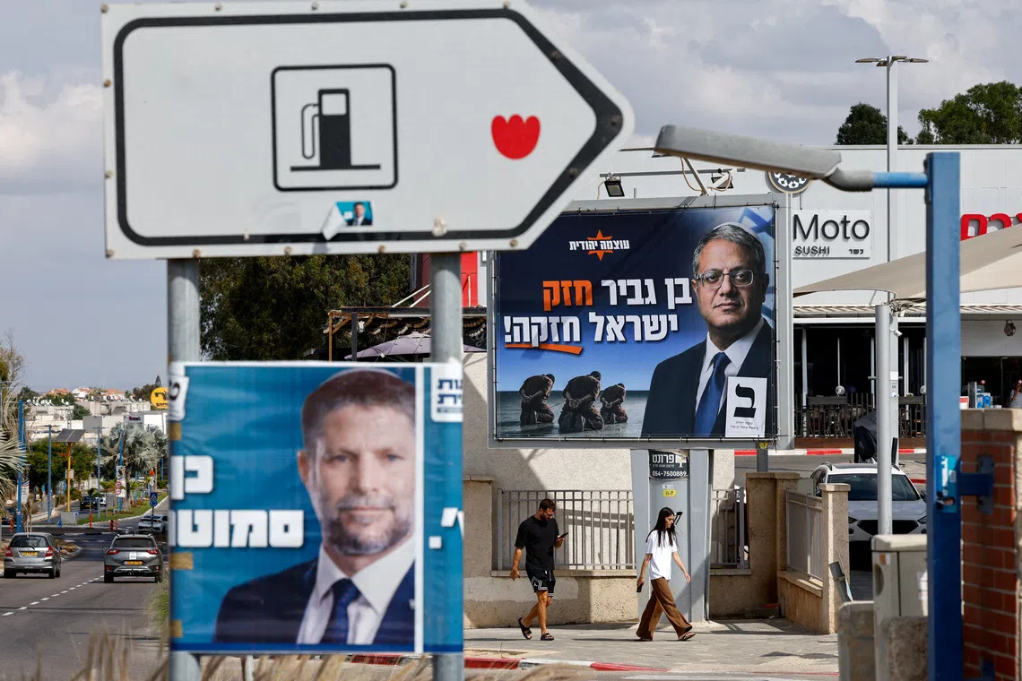 People walk near election banners with images of Israel's National Security Minister Itamar Ben-Gvir, leader of the Jewish Power (Otzma Yehudit) party, and Finance Minister Bezalel Smotrich, leader of the Religious Zionist Party, in Sderot, near Israel's border with Gaza, in southern Israel, October 18, 2026. REUTERS/Amir Cohen     TPX IMAGES OF THE DAY