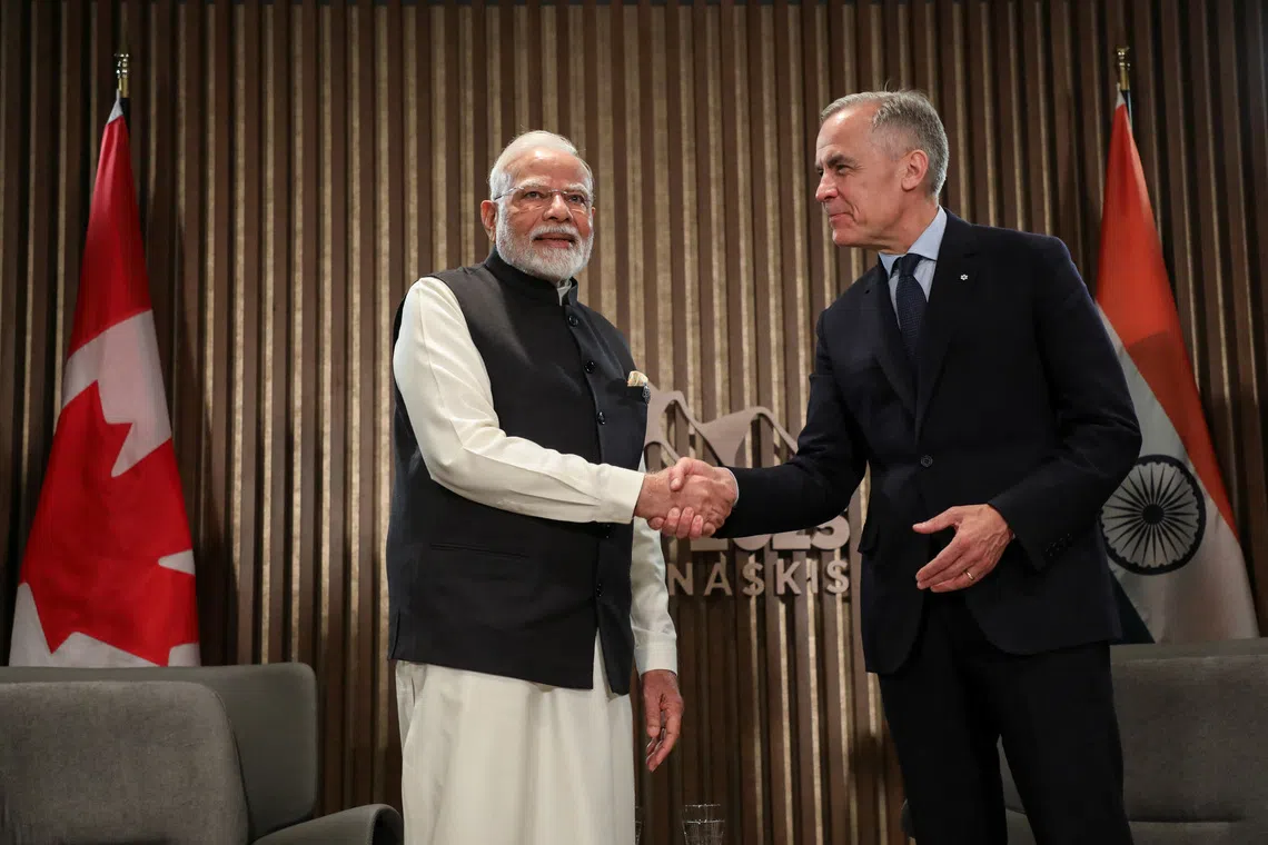 Indian Prime Minister Narendra Modi shakes hands with Canadian Prime Minister Mark Carney as they hold a bilateral meeting during the G7 Leader's Summit in Kananaskis, Alberta, Canada June 17, 2025. REUTERS/Amber Bracken