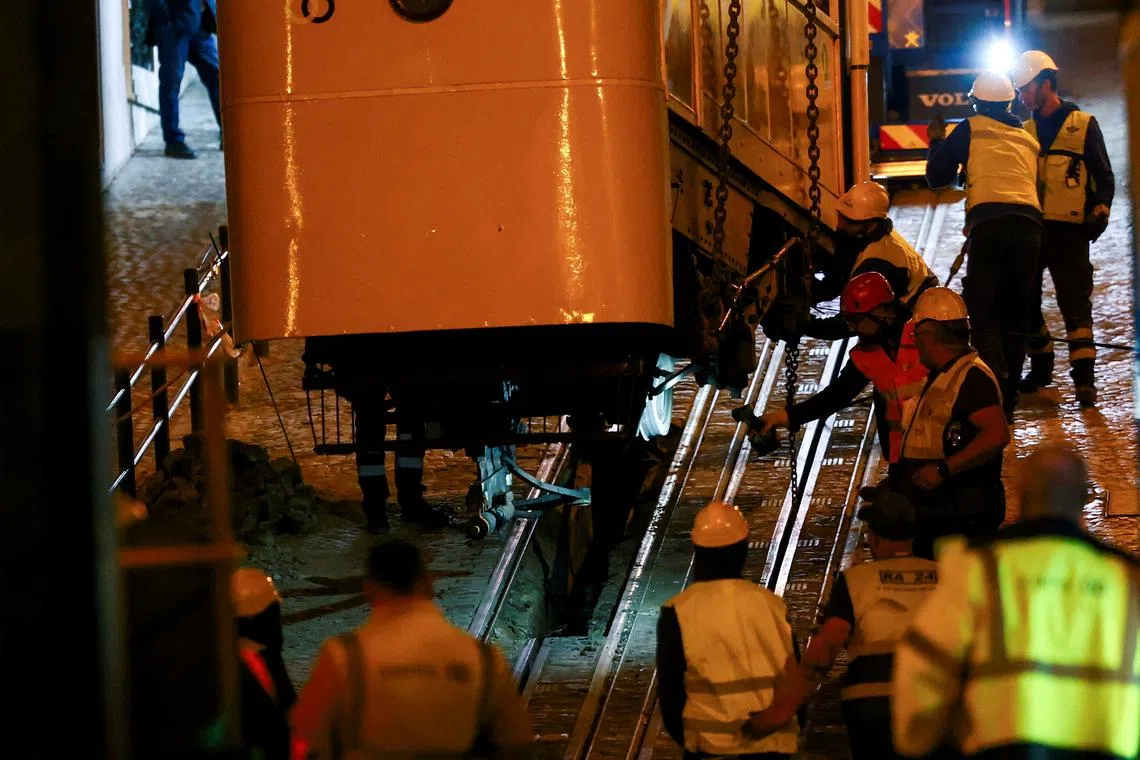 FILE PHOTO: Emergency workers remove one of the funiculars, following derailment and crash of the Gloria funicular railway car, a popular tourist attraction, which resulted in multiple casualties, in Lisbon, Portugal, September 5, 2025. REUTERS/Pedro Nunes/File Photo