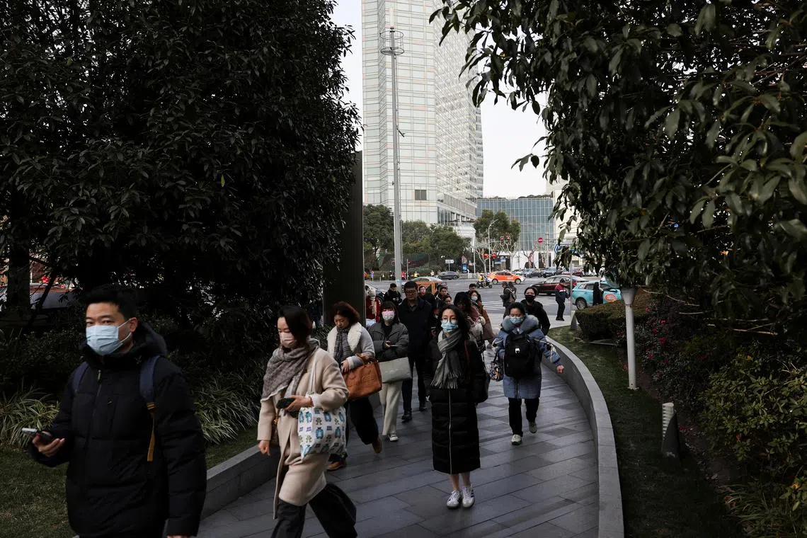 FILE PHOTO: People walk in the Pudong financial district after Lunar New Year holiday in Shanghai, China, February 5, 2025.  REUTERS/Go Nakamura/ File Photo