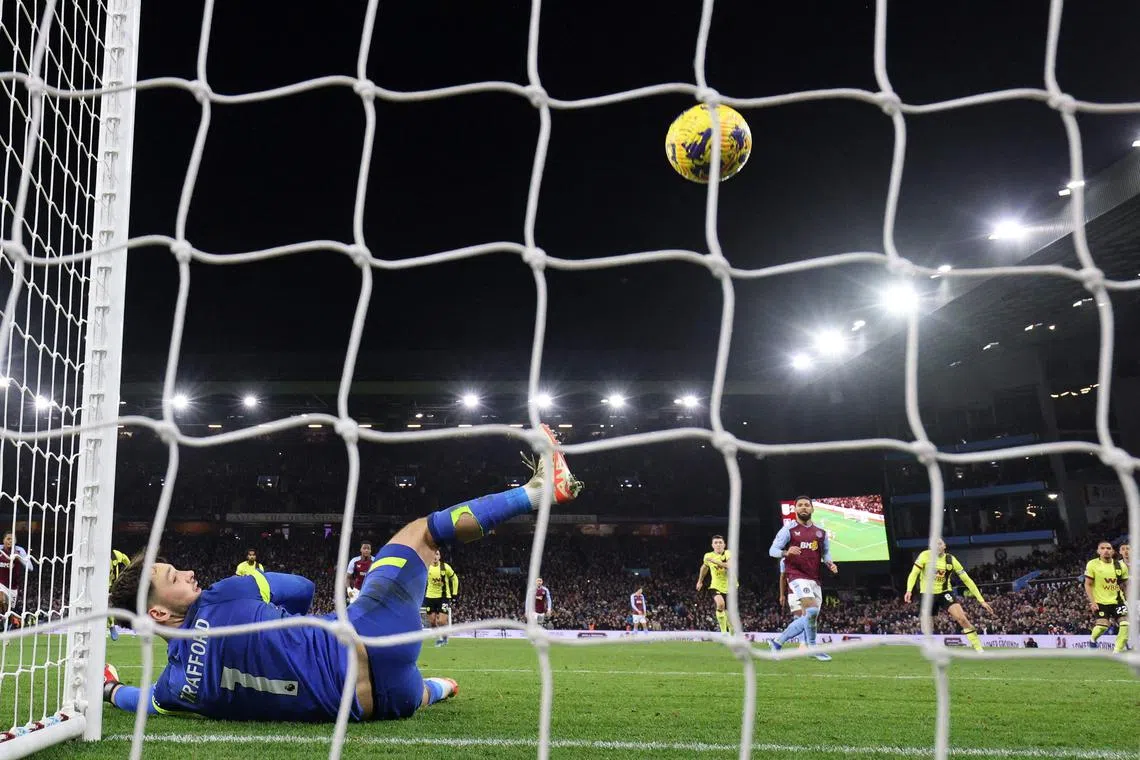 Aston Villa's Douglas Luiz (centre right) sees his 89th-minute penalty hit the crossbar before crossing the line for Villa's third goal. 