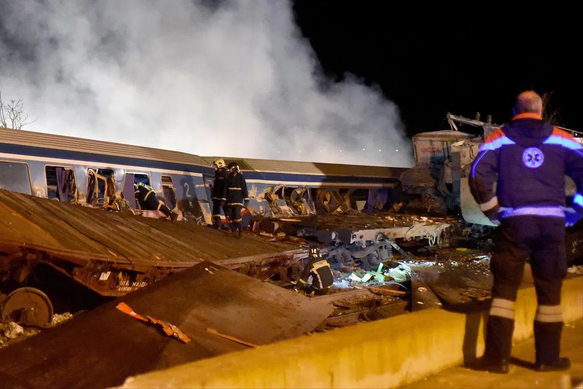 Firefighters working to extricate passengers from trains after a collision near Larissa city, Greece on March 1, 2023. A passenger train travelling from Athens to the northern city of Thessaloniki, and a cargo train from Thessaloniki to Larissa, collided head-on outside the central Greek city, Konstantinos Agorastos, the governor of the Thessaly region told local media. Sixteen people have been killed and at least 85 injured, and 250 passengers were evacuated safely to Thessaloniki on buses. 