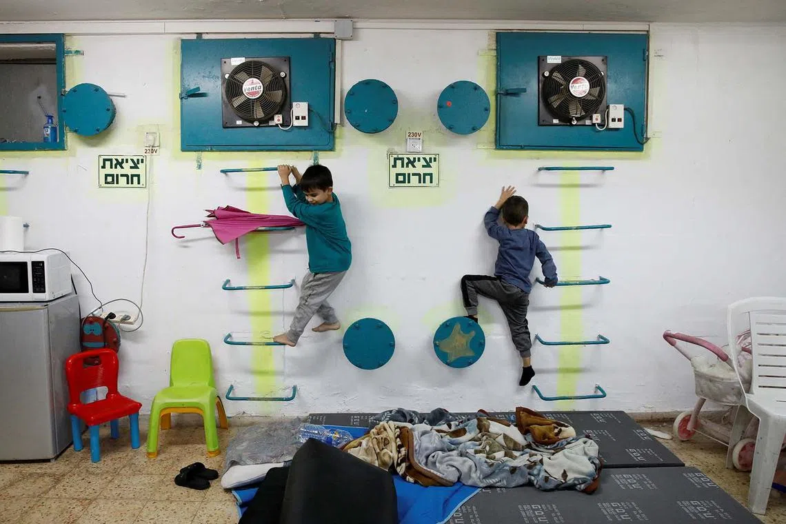 Israeli children playing at a bomb shelter following rocket attacks from Lebanon towards Israel, ahead of a possible ceasefire deal between Israel and Iran-backed Hezbollah, in Acre, northern Israel, Nov 26, 2024. 