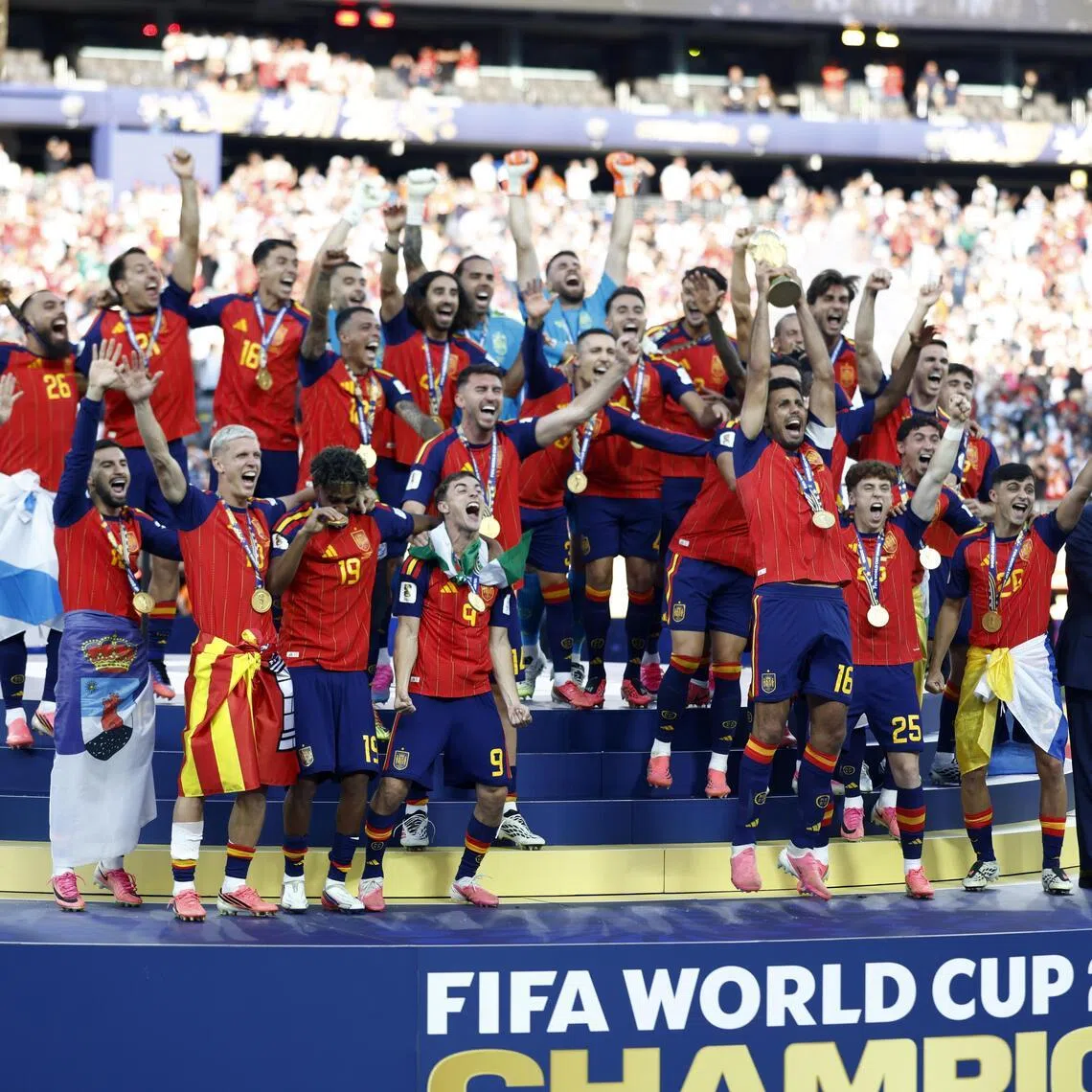 US President Donald Trump and FIFA president Gianni Infantino (far right) on stage as Spain captain Rodri hoists the World Cup trophy on July 19.