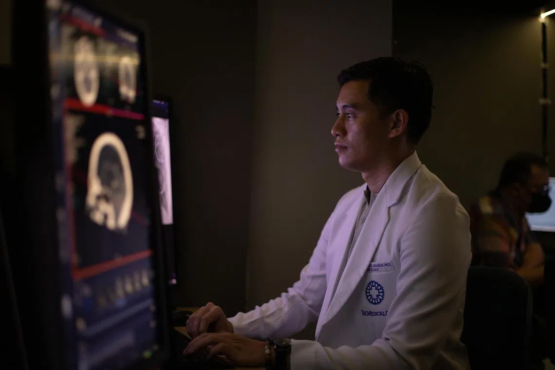 Radiologist Jose Legarda, from The Medical City Hospital in the Philippines' capital, interprets an AI-generated x-ray report.