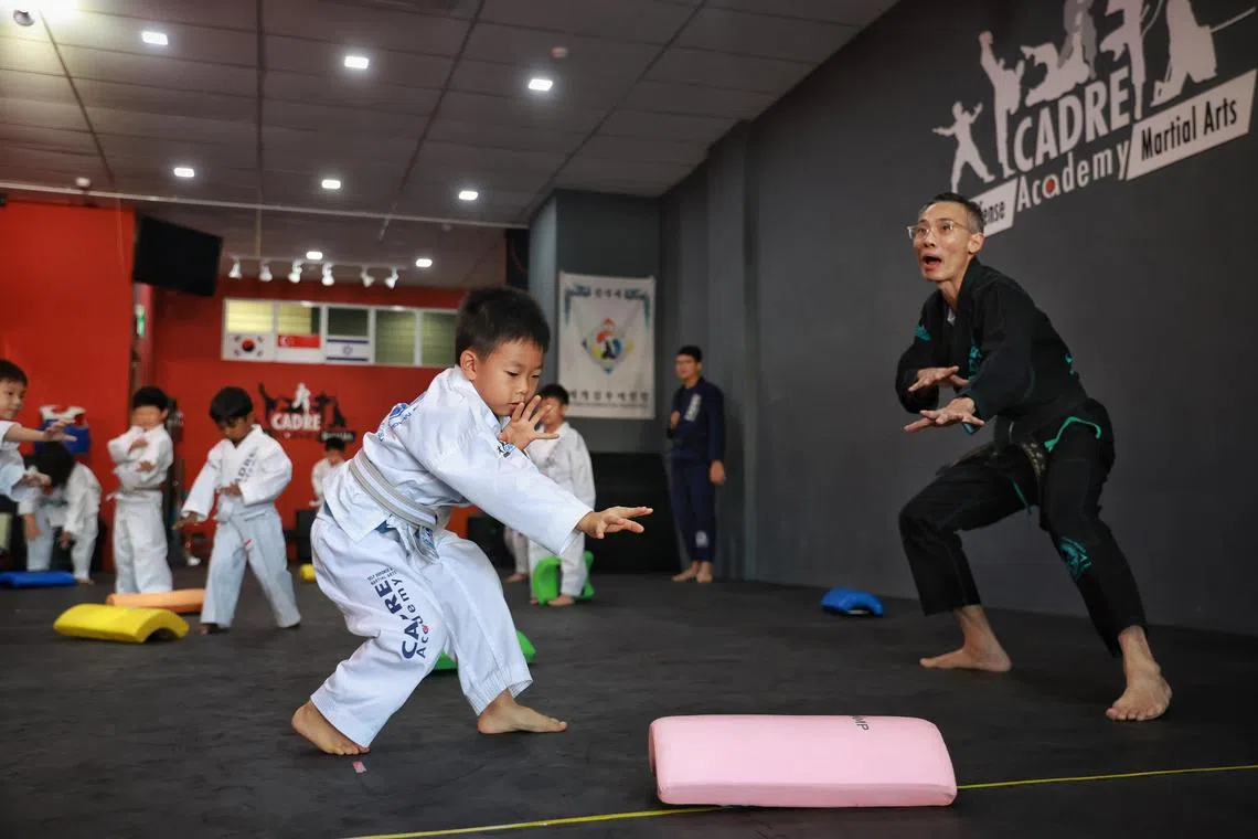 Six-year-old Oliver Pang practising Kapap Krav Maga under the guidance of Master Leon Koh (in black martial arts uniform), founder of Cadre Academy, on July 1, 2023.