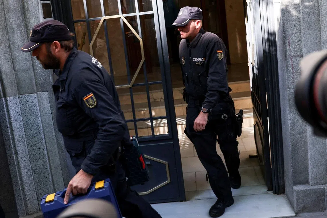 Police officers carry cases from the office of former Spanish Prime Minister Jose Luis Rodriguez Zapatero, who, according to the country's High Court, is being investigated for alleged influence peddling and related crimes, in Madrid, Spain, May 19, 2026.
