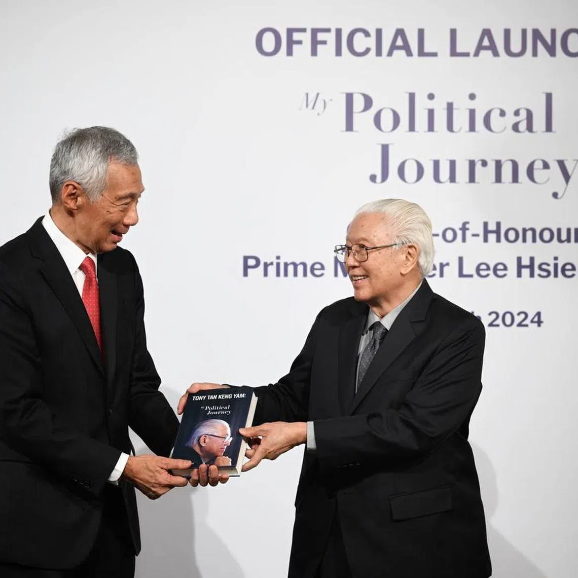 Dr Tony Tan (right) presenting a copy of his book, My Political Journey, to Prime Minister Lee Hsien Loong at the official launch on March 12.