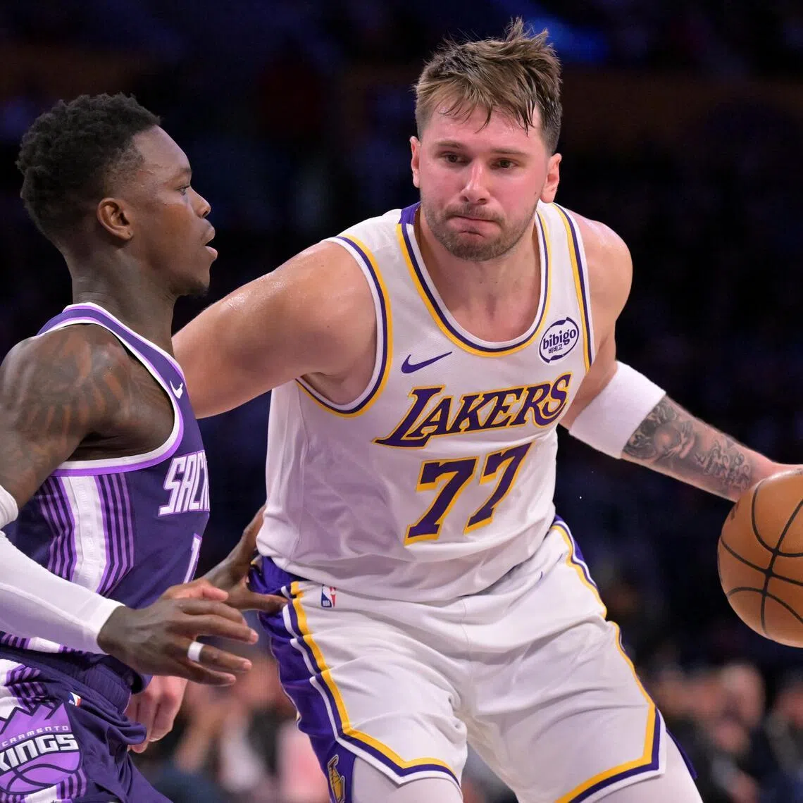 Sacramento Kings guard Dennis Schroder defending Los Angeles Lakers guard Luka Doncic during the Lakers' 125-101 NBA win at Crypto.com Arena on Dec 28, 2025.