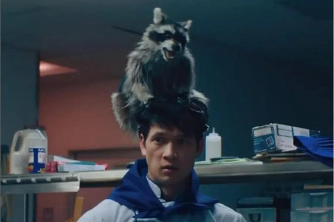 American actor Harry Shum Jr and Raccacoonie in the movie Everything Everywhere All At Once.