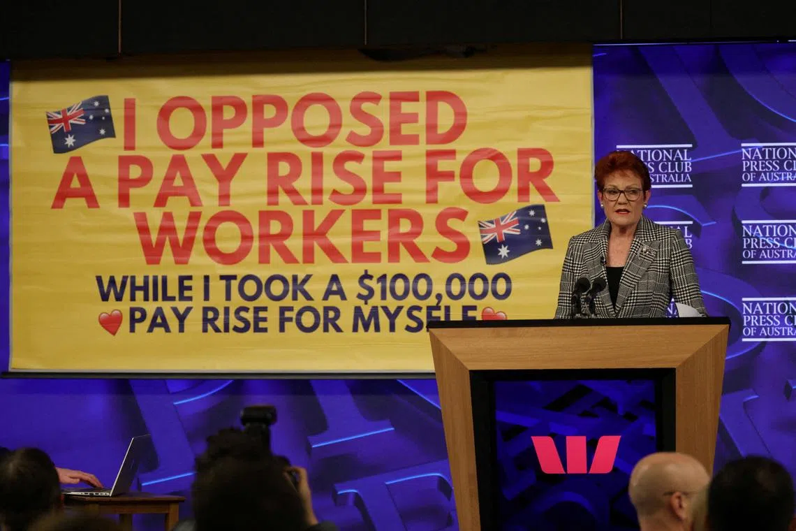 A protest banner appears during Australian Senator and One Nation leader Pauline Hanson's address at the National Press Club in Canberra, Australia, June 17, 2026. REUTERS/Hollie Adams