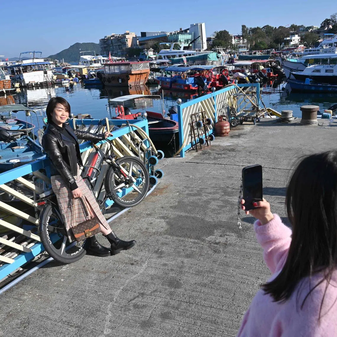 Mainland Chinese tourists taking photos in the Sai Kung district of Hong Kong on Jan 30, 2023.