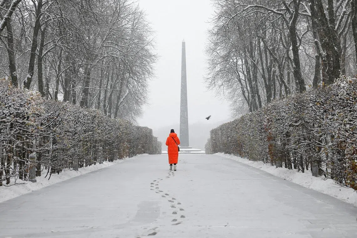 A woman walking in a snow covered park during a first snowfall in Kyiv, Ukraine, on Nov 22, 2023. 