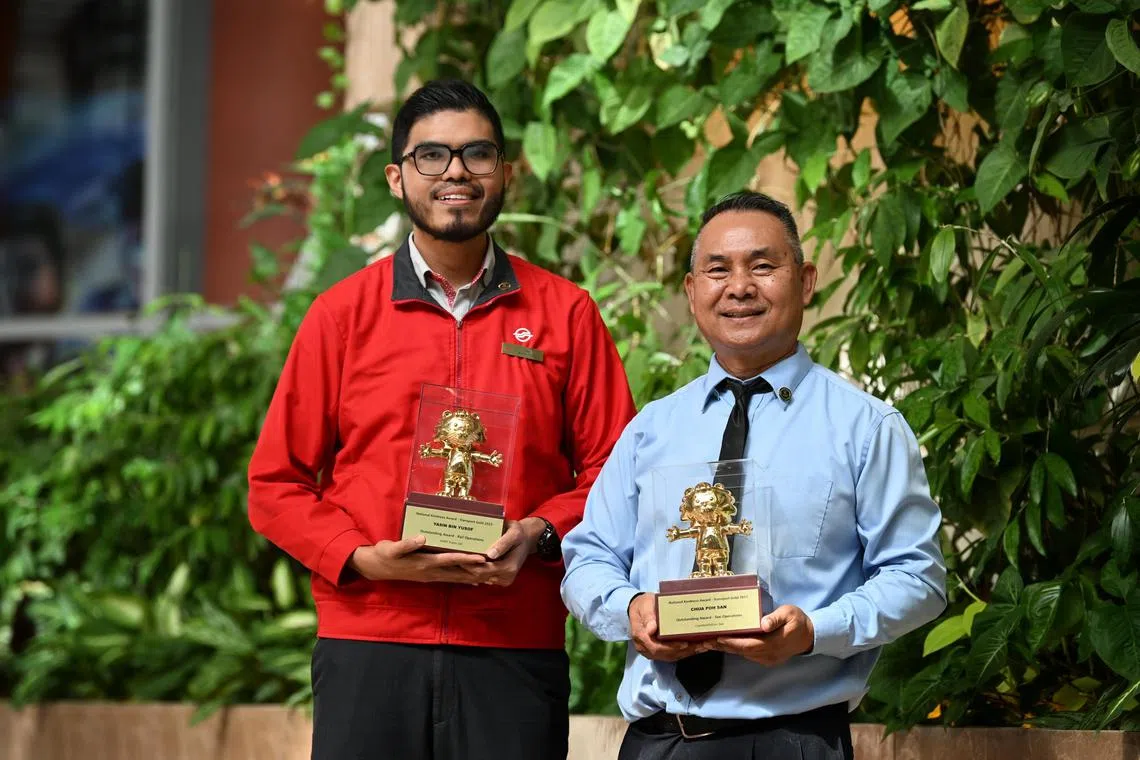 Comfort taxi driver Chua Poh San (right) and SMRT station manager Yasin Yusoff with their Transport Gold Awards on Dec 12, 2023.