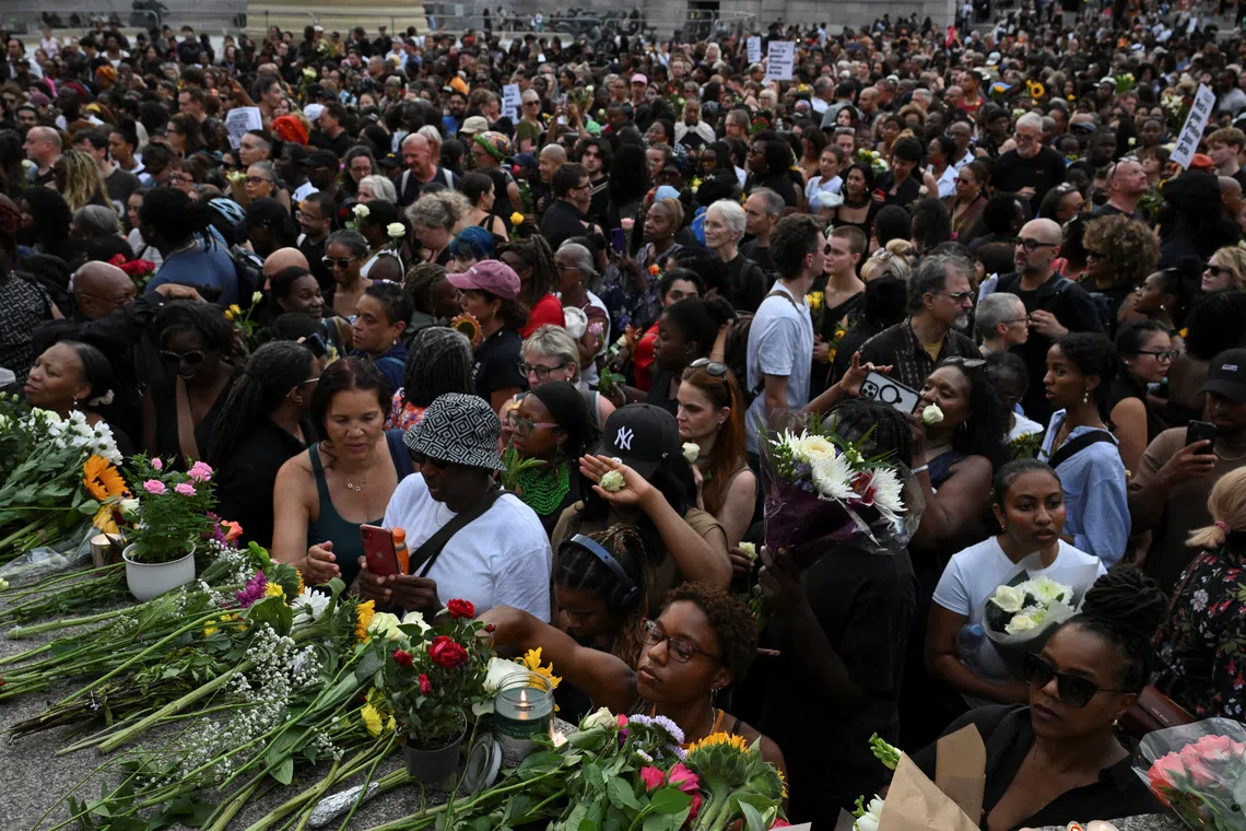 People lay flowers at Trafalgar Square in London during a vigil to remember former Cambridge professor Jason Arday, who died on Aug 14 after resigning amid plagiarism allegations which he denied.