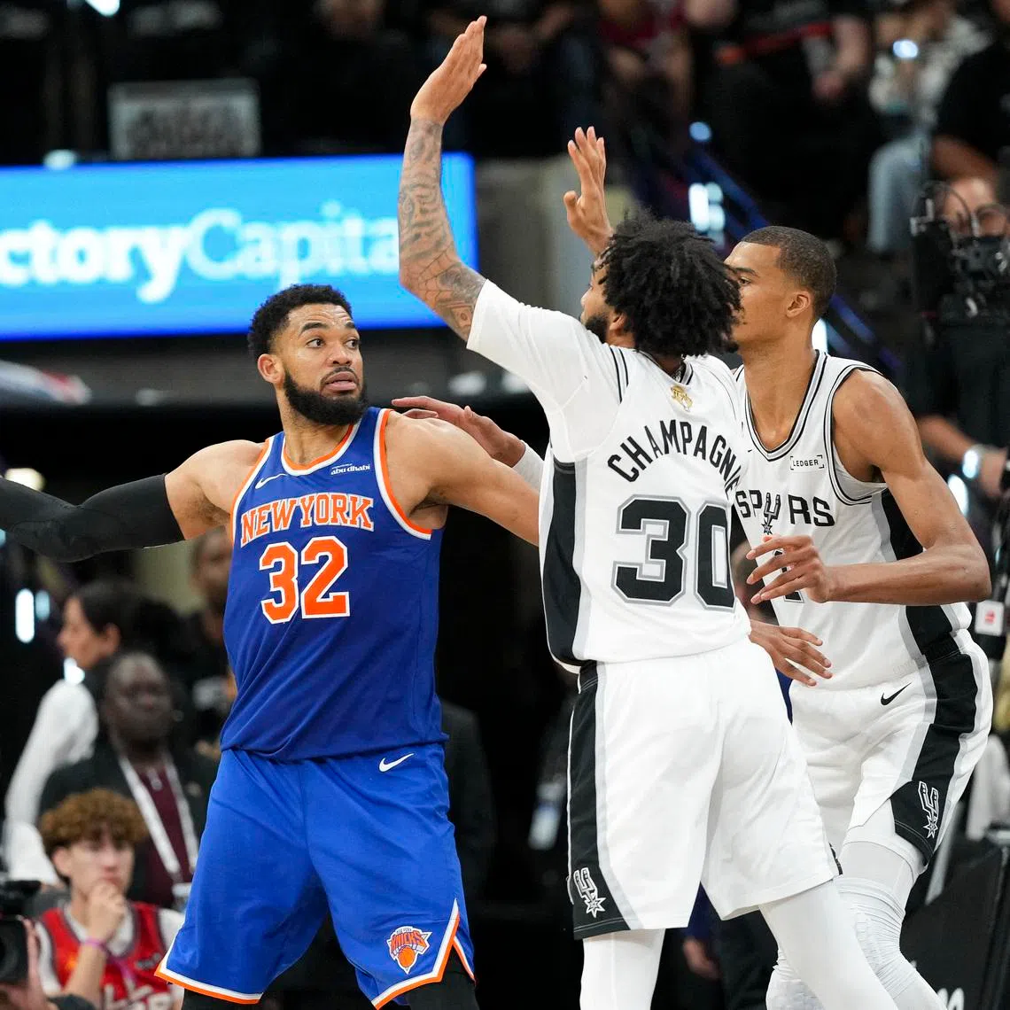 Jun 5, 2026; San Antonio, Texas, USA; New York Knicks center Karl-Anthony Towns (32) looks to passes the ball past San Antonio Spurs forward Julian Champagnie (30) and forward Victor Wembanyama (1) in the second half during game two of the 2026 NBA Finals at Frost Bank Center. Mandatory Credit: Scott Wachter-Imagn Images