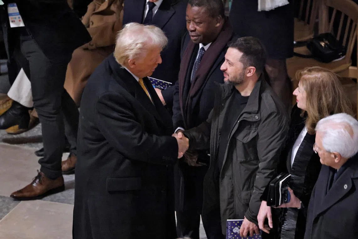 US President-elect Donald Trump (left) shaking hands with Ukrainian President Volodymyr Zelensky ahead of the Dec 7 re-opening of France's Notre-Dame Cathedral.