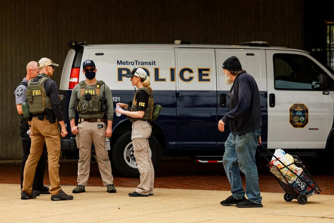 FILE PHOTO: FBI agents gather in front of a Metro Transit Police van near the Anacostia bus station, after U.S. President Donald Trump deployed U.S. National Guard troops to Washington and ordered an increase in the presence of federal law enforcement to assist in crime prevention, in Washington, D.C., U.S., August 20, 2025. REUTERS/Jose Luis Gonzalez/File Photo