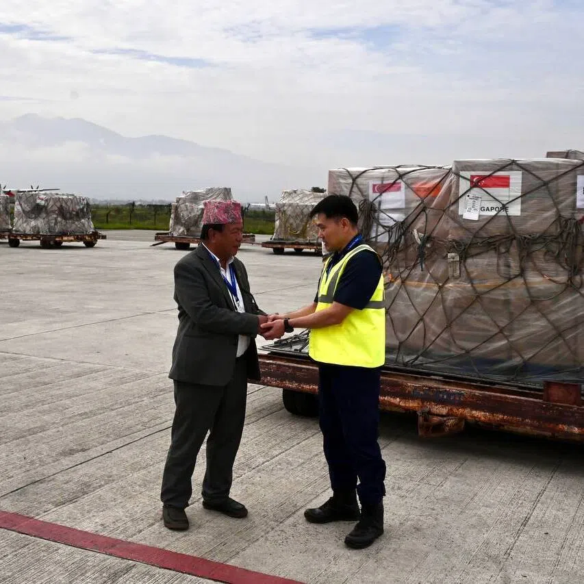 (From left) Nepal’s Minister for Science, Technology and Innovation Mahabir Pun and Singapore’s Assistant Commissioner of Police Patrick Tan at the handover of humanitarian aid at Tribhuvan International Airport, Kathmandu, on Sept 10.