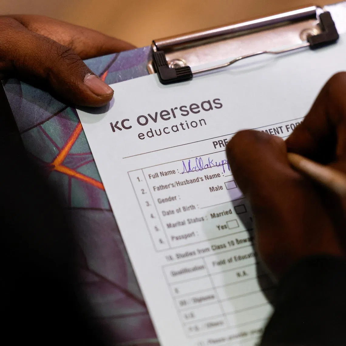 A student fills a pre-assessment form before counselling at the office of KC Overseas Education, an education consultancy, in Bengaluru, India, on Feb 18.