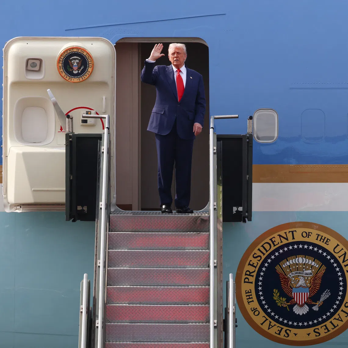 US President Donald Trump gestures as he boards the Air Force One at Gimhae International Airport in Busan, South Korea, on Oct 30.