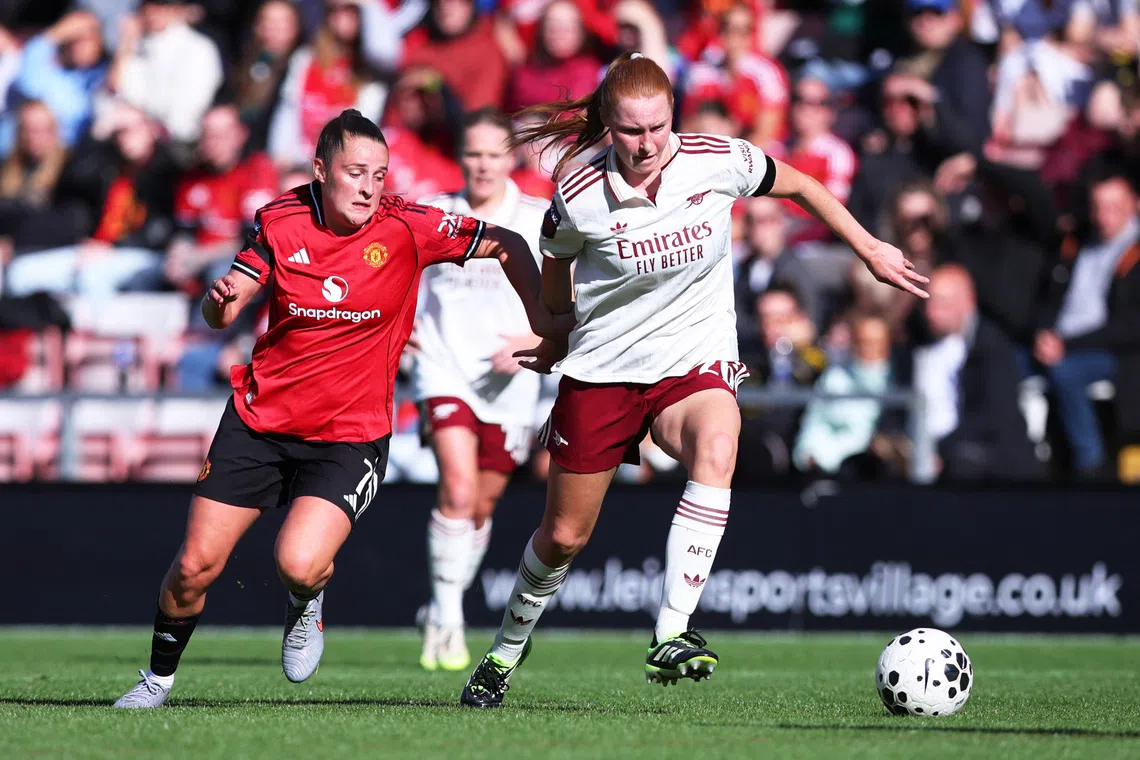 Soccer Football - Women's Super League - Manchester United v Arsenal - Leigh Sports Village, Leigh, Britain - September 21, 2025 Arsenal's Katie Reid in action with Manchester United's Ella Ann Toone Action Images via Reuters/Craig Brough