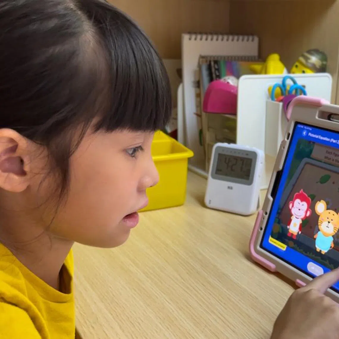A primary school pupil learning about pictorial equations via a live online class on the Spark Education platform.