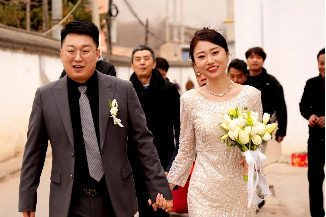 Ms Droya Zhuo wearing her simple bridal gown bought for her by her husband at a clothing store near her workplace.