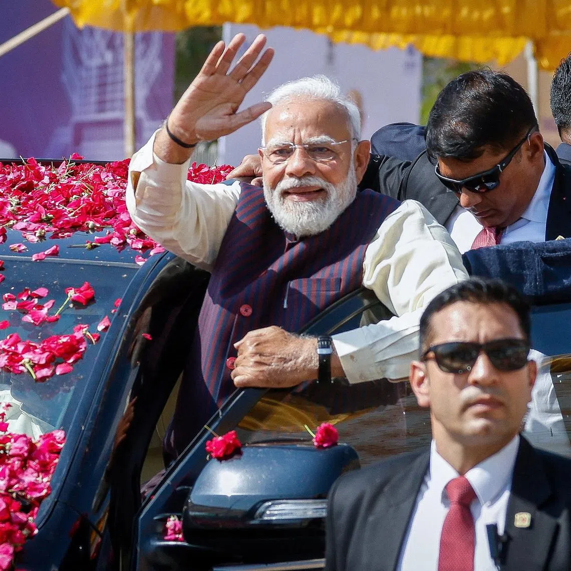 India's Prime Minister Narendra Modi waves to the crowd as he arrives to inaugurate Micron Technology's semiconductor assembly and testing plant in Sanand, Gujarat on Feb 28.