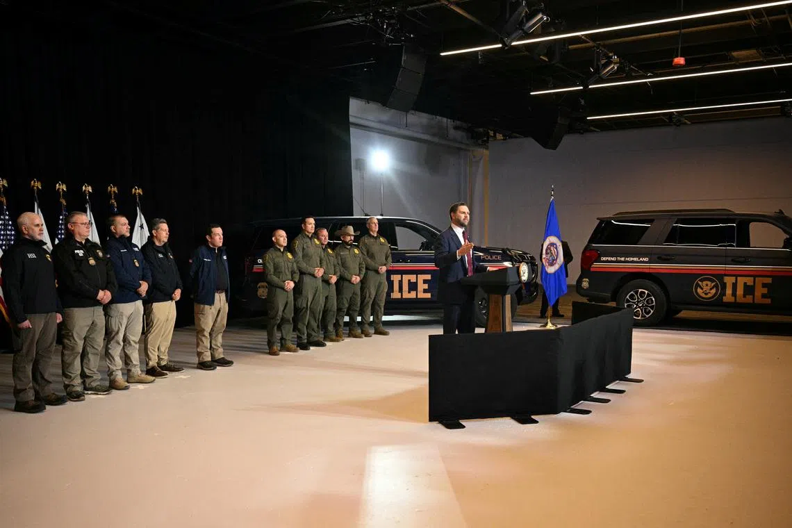 ICE vehicles sit in the background as federal immigration agents listen to U.S. Vice President JD Vance speak at Royalston Square in Minneapolis, Minnesota, U.S. January 22, 2026. Jim Watson/Pool via REUTERS