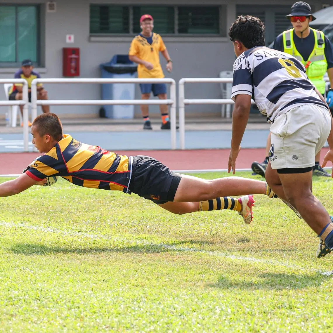 ACS(I) captain Jenson Lim diving for a try during the C Division boys’ rugby final against St Andrew’s School (Secondary) at Jurong West Stadium on Aug 24. ACS(I) won 33-5.