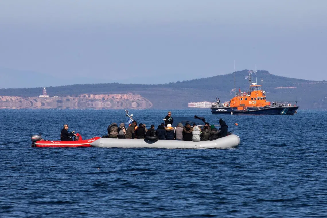 FILE PHOTO: Migrants on a dinghy with a damaged engine are helped by coast guard rescuers to reach the port of Thermi, as they cross part of the Aegean Sea from Turkey to the island of Lesbos, Greece, March 1, 2020. REUTERS/Alkis Konstantinidis/File Photo