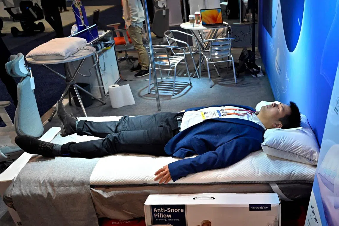 LAS VEGAS, NEVADA - JANUARY 06: Nitetronic representative Charlie Han demonstrates the smart air mattress topper and smart anti-snore pillow during CES 2023 at the Las Vegas Convention Center on January 6, 2023 in Las Vegas, Nevada. CES, the world's largest annual consumer technology trade show, runs through January 08 and features about 3,200 exhibitors showing off their latest products and services to more than 100,000 attendees.   David Becker/Getty Images/AFP (Photo by David Becker / GETTY IMAGES NORTH AMERICA / Getty Images via AFP)