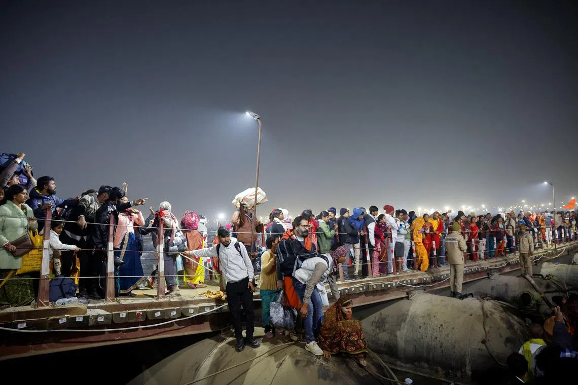 Devotees walk from a pontoon bridge after a deadly stampede before the second \"Shahi Snan\" (royal bath) at the \"Maha Kumbh Mela\", or the Great Pitcher Festival, in Prayagraj, previously known as Allahabad, India, January 29, 2025. REUTERS/Sharafat Ali